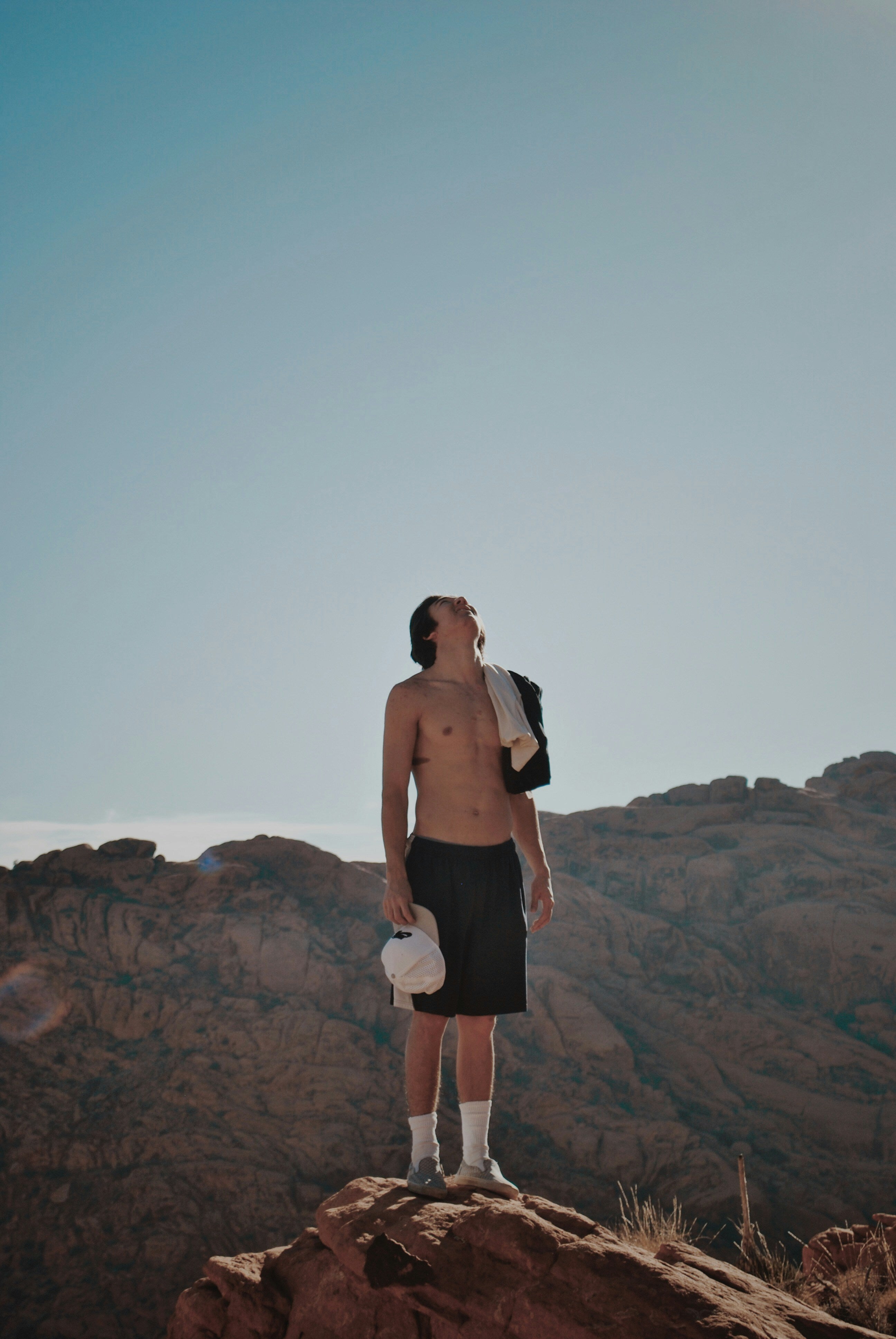 An athlete on a summit, looking to the open sky